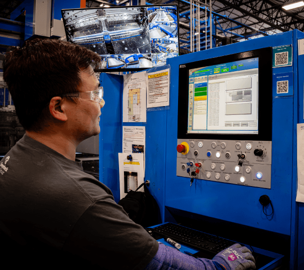 Technician operating automated manufacturing equipment at Valent